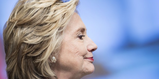 Former Secretary of State Hillary Clinton waits to speak at the World Bank May 14, 2014 in Washington, DC. Former Secretary of State Hilary Clinton and World Bank President Jim Yong Kim joined others to speak about women's rights. AFP PHOTO/Brendan SMIALOWSKI        (Photo credit should read BRENDAN SMIALOWSKI/AFP/Getty Images)